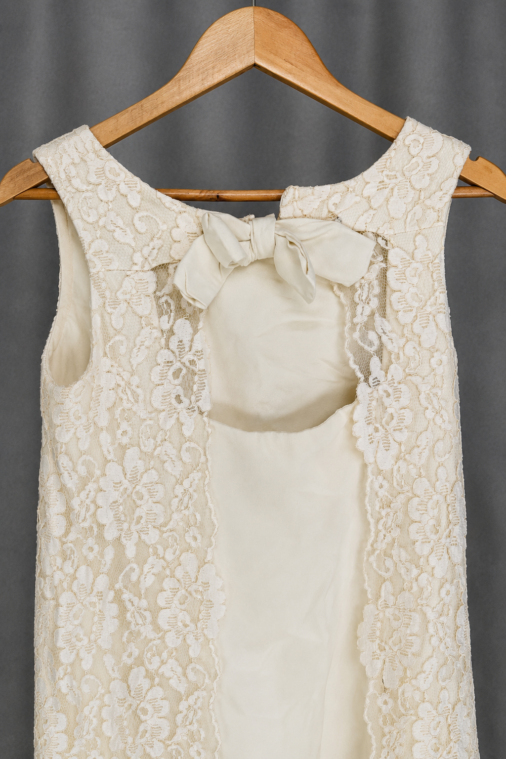 Lace panels over solid center, bow at neckline