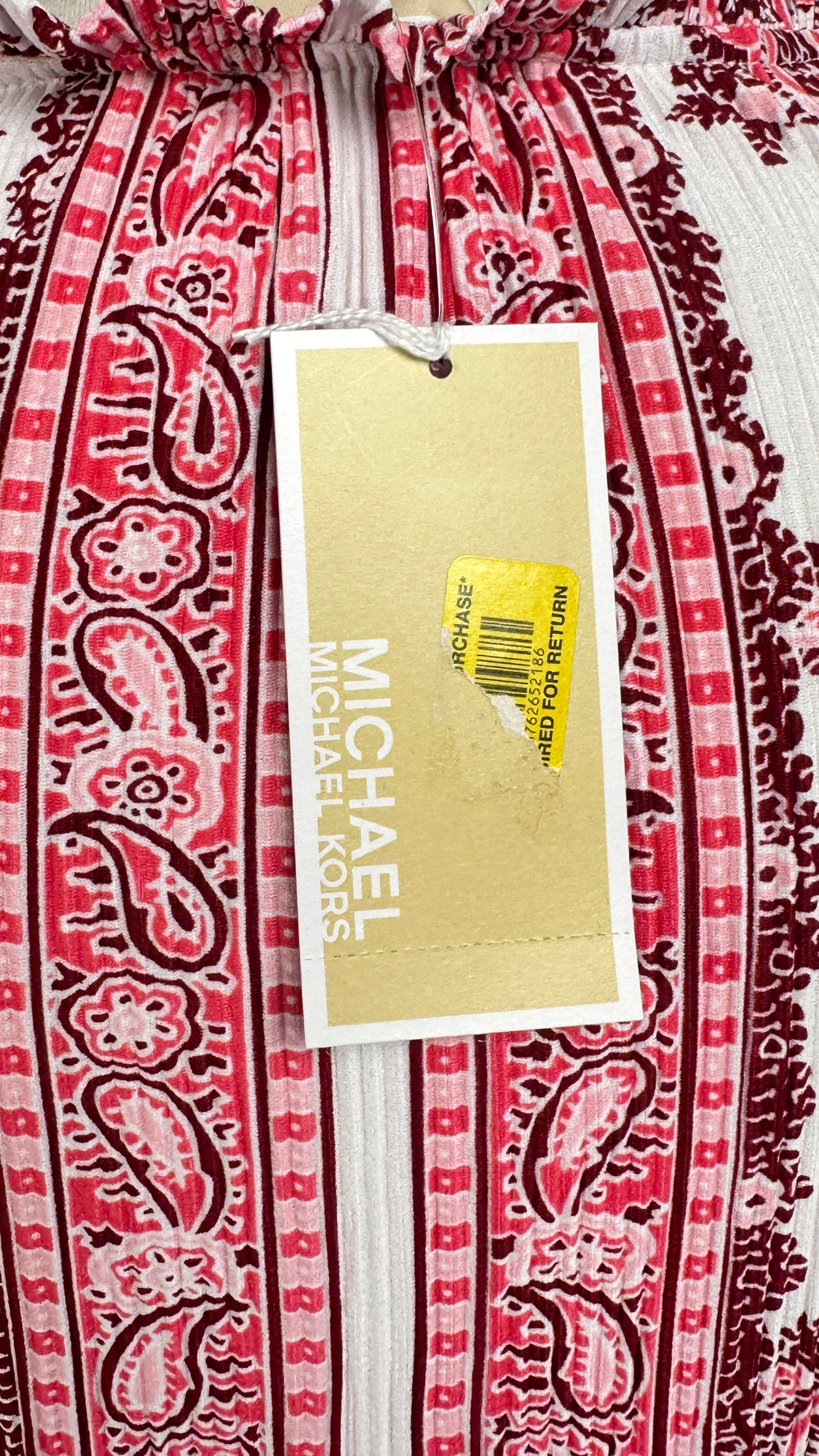Red and white patterned pants with a Michael Kors tag on a red and white patterned background