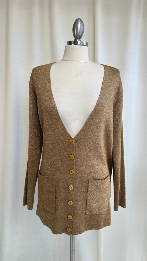 Brown cardigan on a mannequin against a plain background