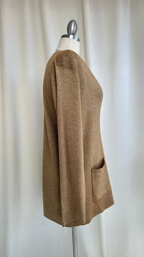 Brown cardigan on a mannequin against a plain background
