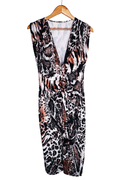 Sleeveless dress on a wooden hanger, front view. Deep V-neckline with a gathered twist knot at the center waist. Mixed animal print combining tiger stripe, leopard spot, and snakeskin motifs in brown, black, tan, and white.