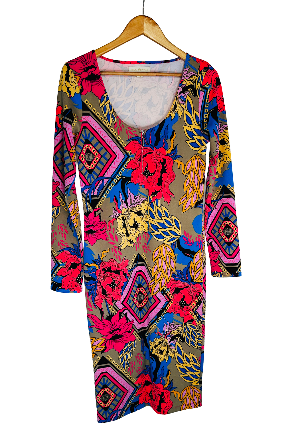 Long-sleeve dress on a wooden hanger, front view. Scoop neckline with a short silver center-front zip. Mixed print of geometric diamond medallions and oversized florals in red, pink, gold, and blue over an olive ground.