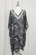 Black and white patterned dress on a mannequin against a white background
