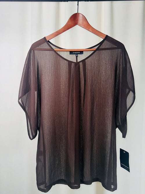 Sheer black top on a hanger against a white background