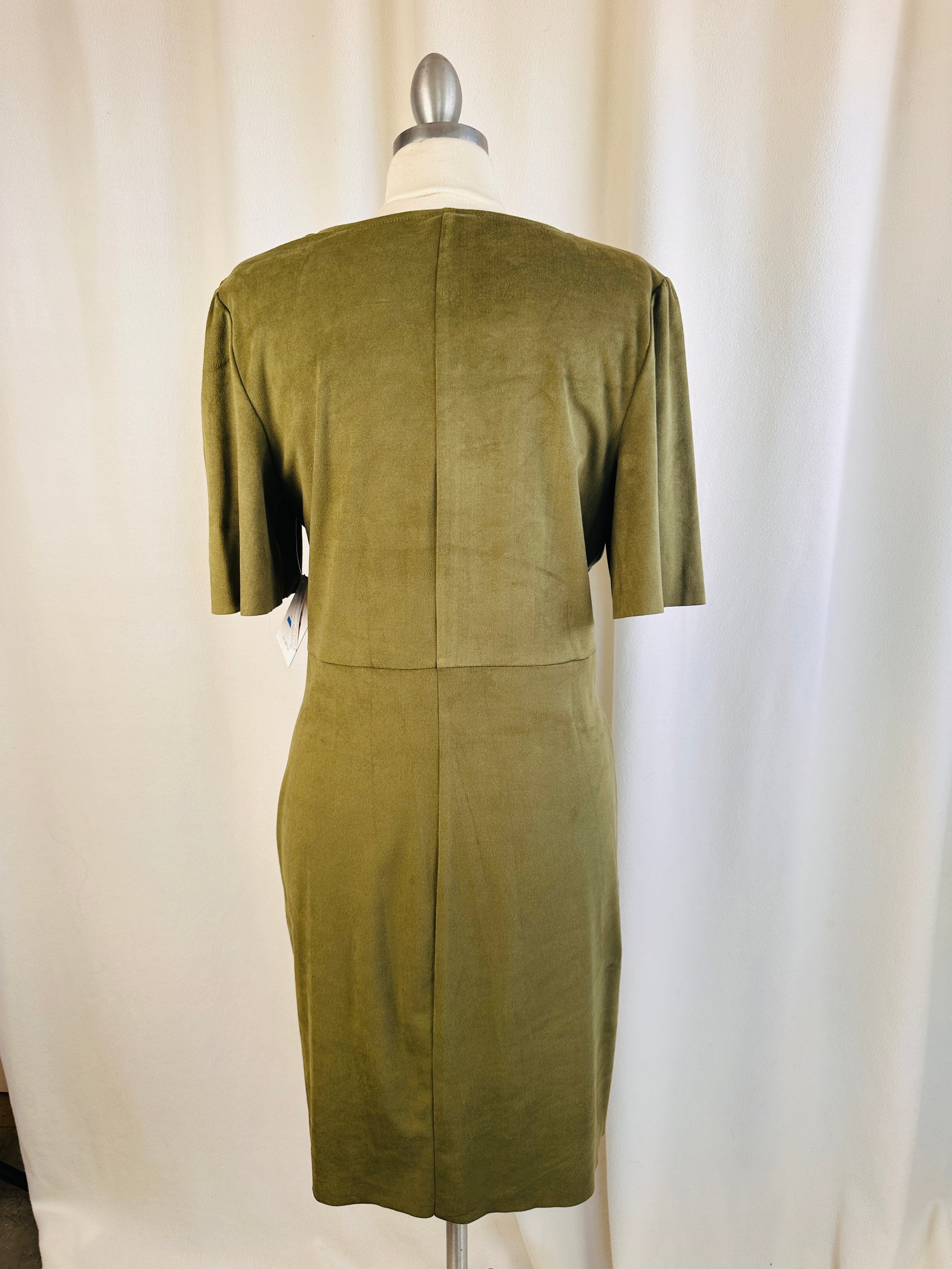 Green dress on a mannequin against a white background