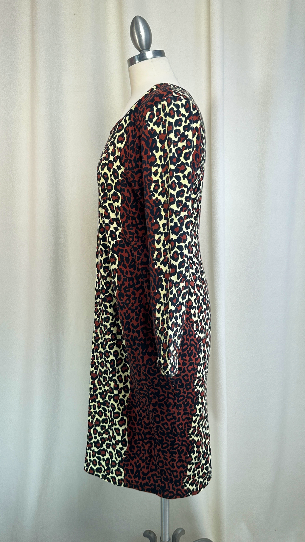 Leopard print dress on a mannequin against a plain background