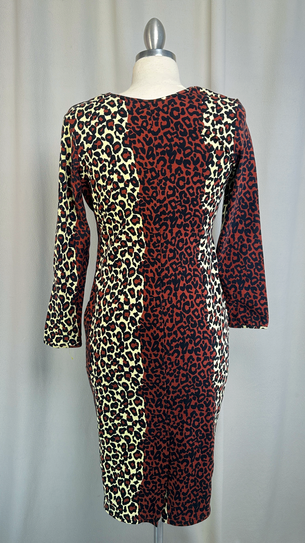 Leopard print dress on a mannequin against a plain background