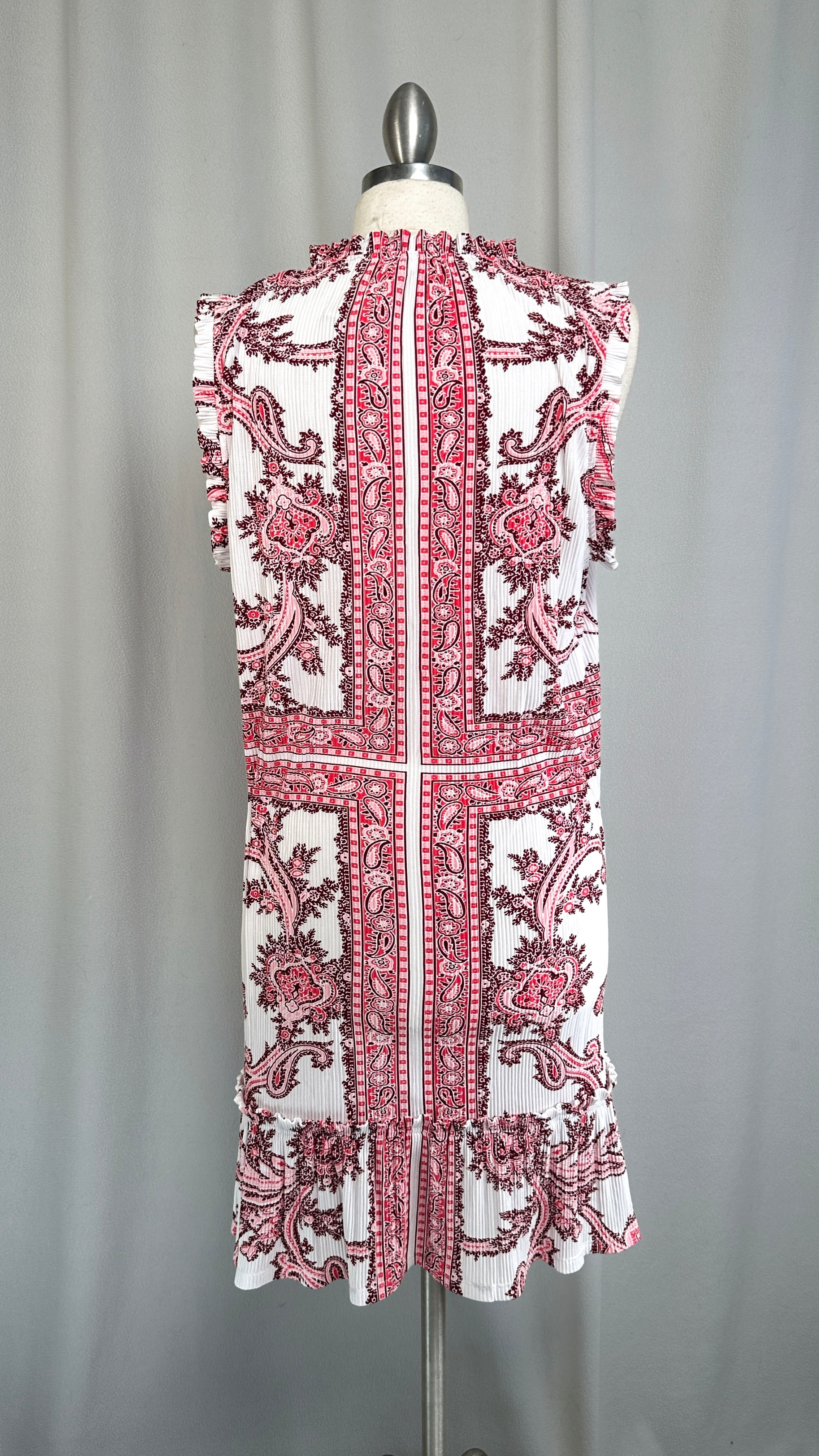 White dress with red floral patterns on a mannequin against a gray background