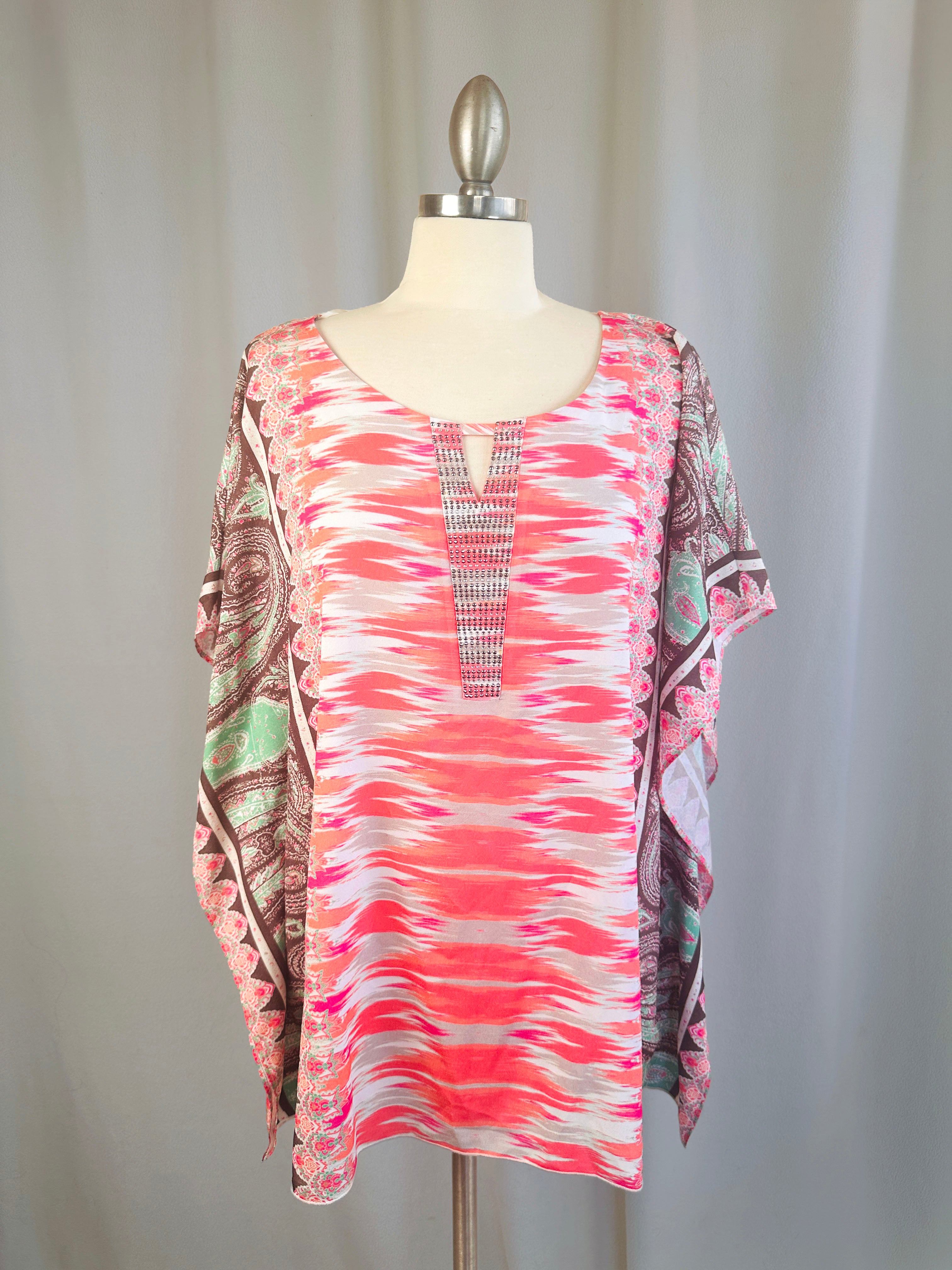 Colorful patterned top on a mannequin against a plain background