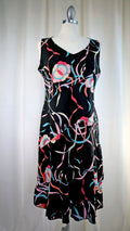 Black dress with colorful floral pattern on a mannequin against a white background