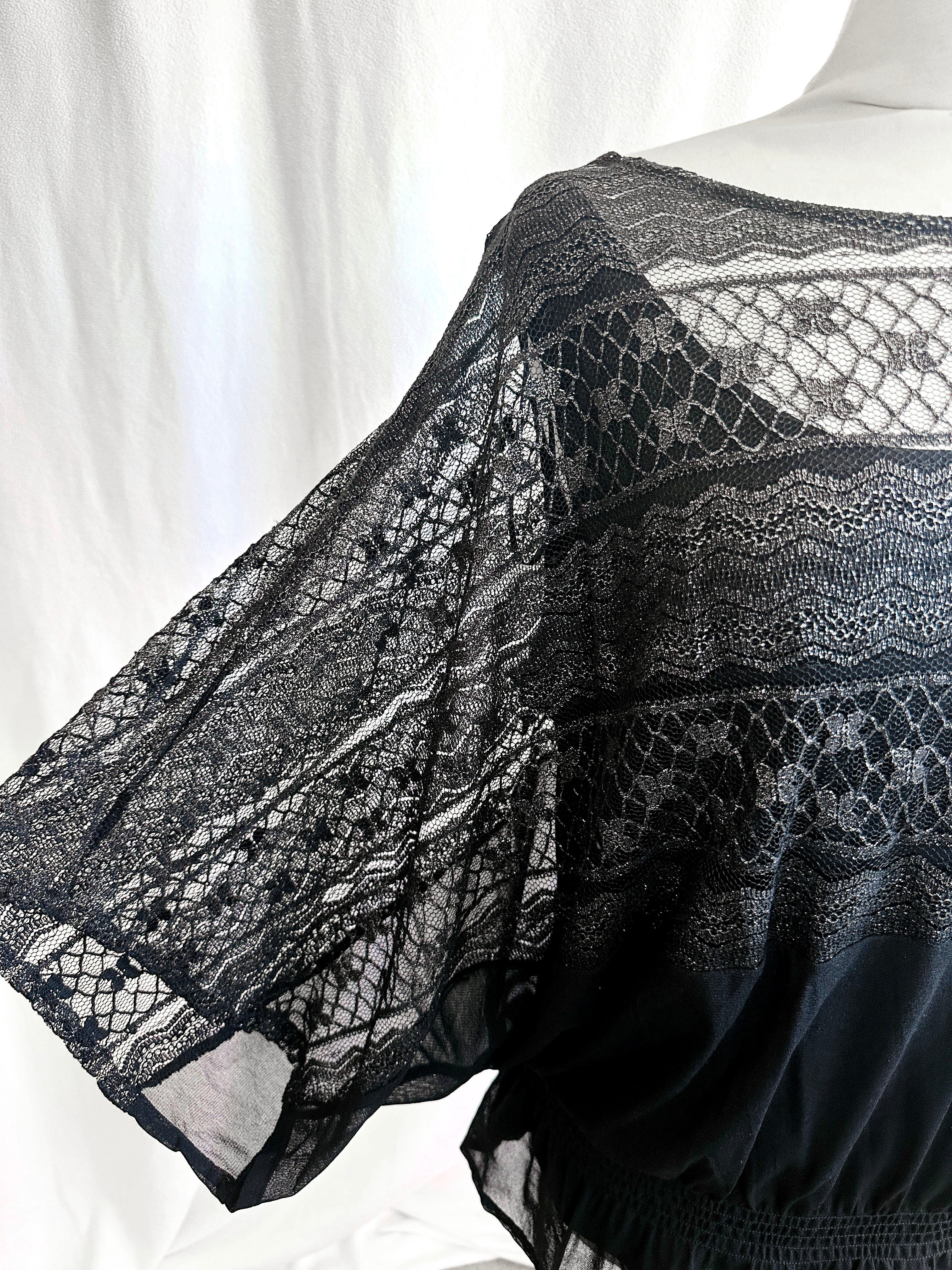 Black lace garment on a mannequin against a white background